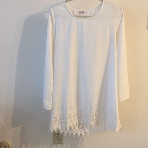 White shift dress with bell sleeves and lace trim